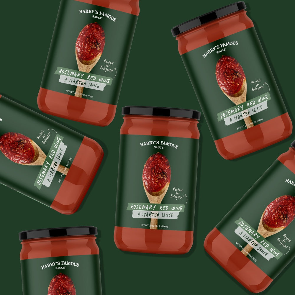 Multiple jars of 'Harry's Famous' rosemary red wine starter sauce on a green background