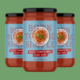 Three jars of 'Harry's Famous' rustic tomato basil sauce on a green background